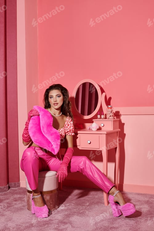 Preview: young and beautiful woman holding lips shape pillow near vanity table with mirror, feminine