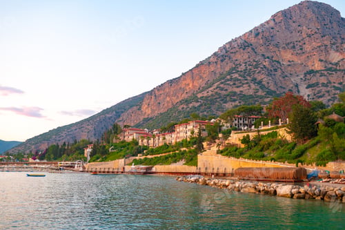 Preview: Scenic view of mountains by the sea