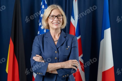 Preview: Mature successful political leader crossing arms by chest