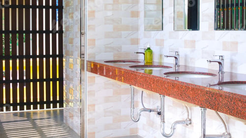 Preview: Public restroom with washbasin on beige tiled wall and wooden sunshade fin facade in vintage style