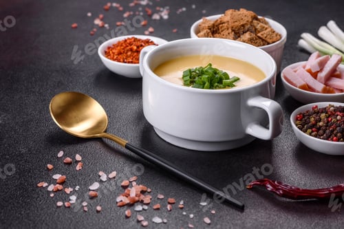 Preview: Cream soup with potatoes, leek and peas on a dark concrete table