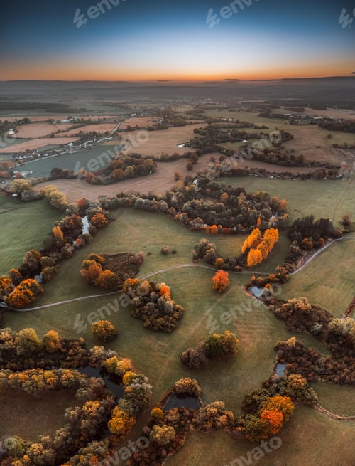 Preview: Aerial shot of a landscdape in autumn during the sunset