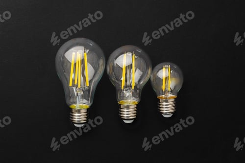 Preview: Compact light bulb isolated on black background