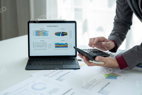 Preview: A man is looking at a laptop with a summary report on it