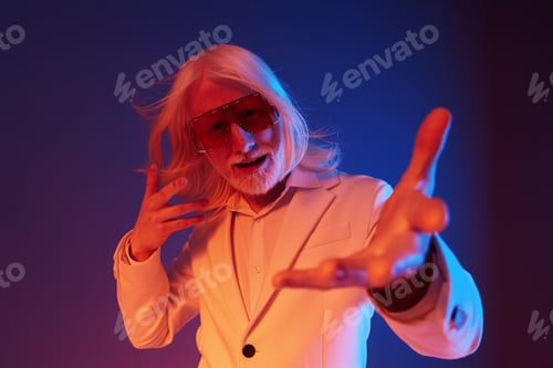 Preview: stylish elderly man with long white hair in sunglasses, posing dramatically against a vibrant blue