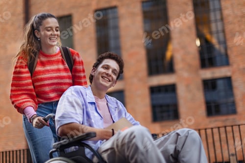 Preview: Handsome gen Z boy in wheelchair with friend in the city. Inclusion, equality, and diversity among