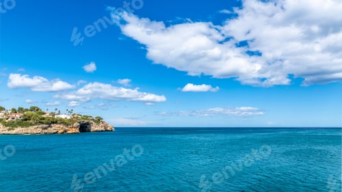 Preview: Landscape of the rocky shore surrounded by the sea on a sunny day in Mallorca, Spain