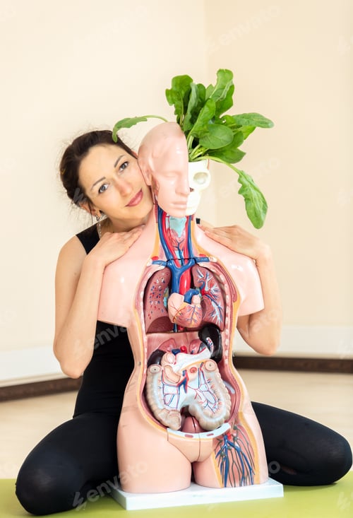 Preview: A Yoga Coach Sits Next To A Medical Dummy