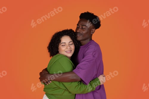Preview: Portrait of emotional multiracial young couple bonding on red