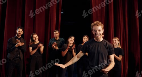 Preview: Group of actors in dark colored clothes on rehearsal in the theater