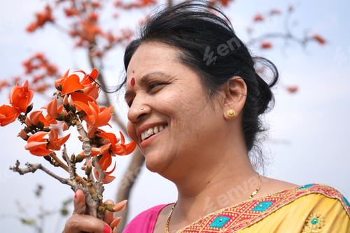 Preview: Portrait of Indian woman with flower in outdoor.
