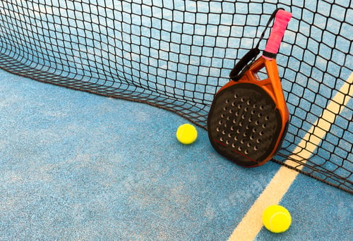 Preview: padel racket on a padel blue court with a ball