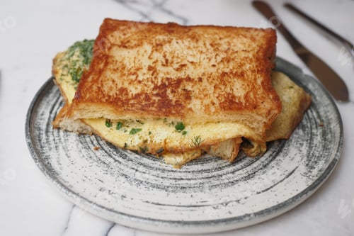 Preview: A delicious and beautifully presented omelette served with toast on a rusticstyle plate