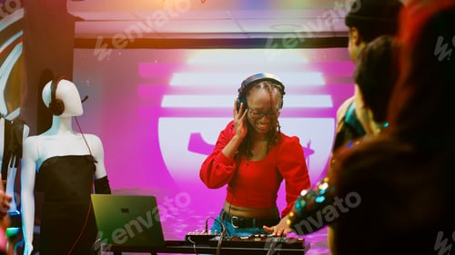 Preview: Happy DJ woman mixing sounds on station