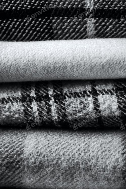 Preview: Stack of woolen checked blankets