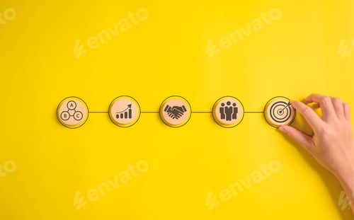 Preview: Hand putting business icons on wooden cubic blocks