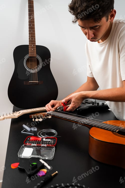 Preview: Musician trims fresh guitar strings with pliers during classical restringing. Cutting process