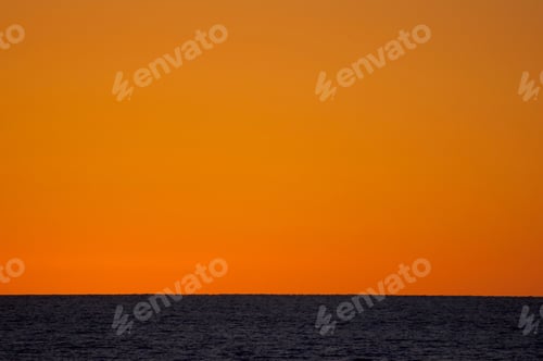 Preview: Wow! Amazing awesome orange sunset turned the whole sky smooth and peaceful over the ocean.