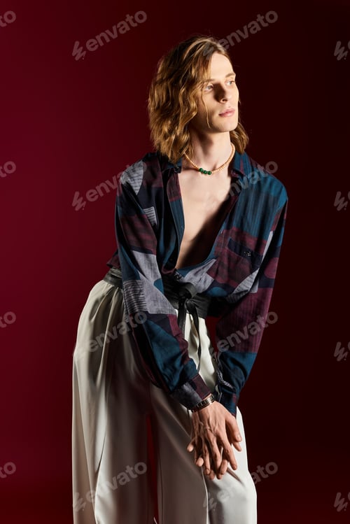 Preview: Charming young man showcases bold fashion choices in striking indoor setting