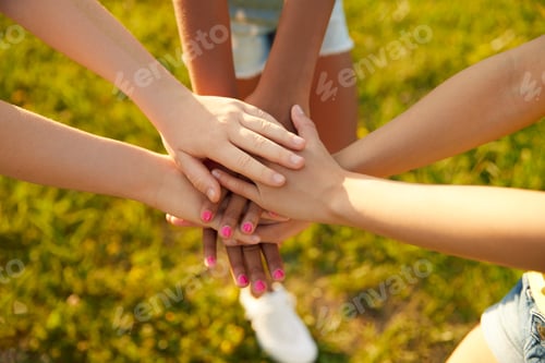 Preview: Diverse children stacking hands together