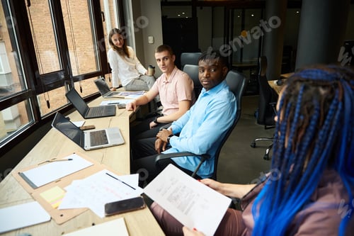 Preview: Three male and female colleagues listening to their female teamlead