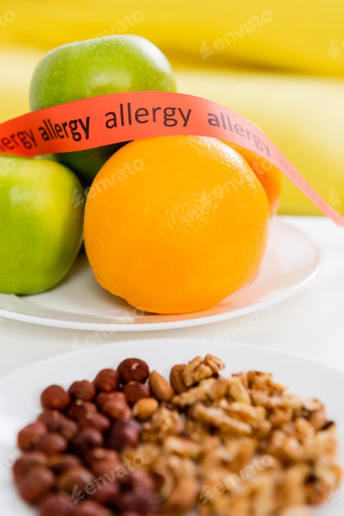 Preview: Ribbon with allergy lettering near fresh fruits and nuts on blurred foreground