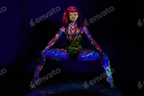 Preview: Full length portrait of a young woman posing with neon paint on her face