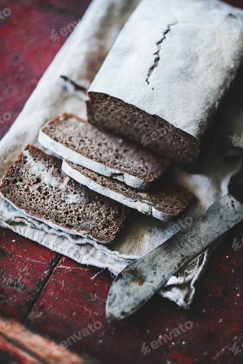 Preview: Rye Swedish bread loaf cut in slices with vintage knife