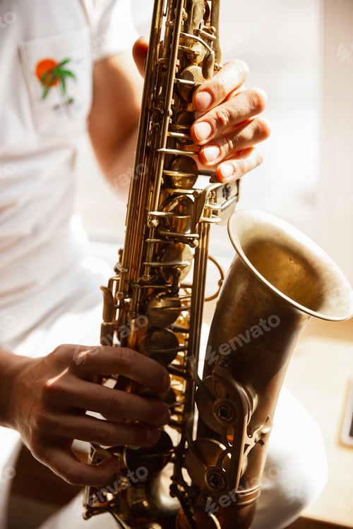 Visualização: Close up of caucasian musician playing saxophone during concert at home isolated and quarantined