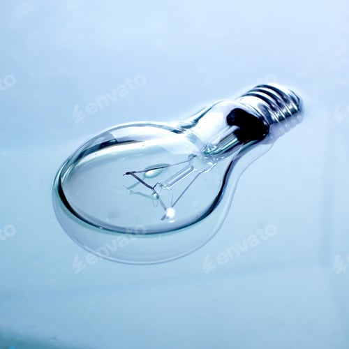 Preview: Illuminating Glass Lightbulb on a Pale Blue Surface