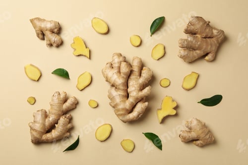 Preview: Fresh ginger and leaves on beige background, top view