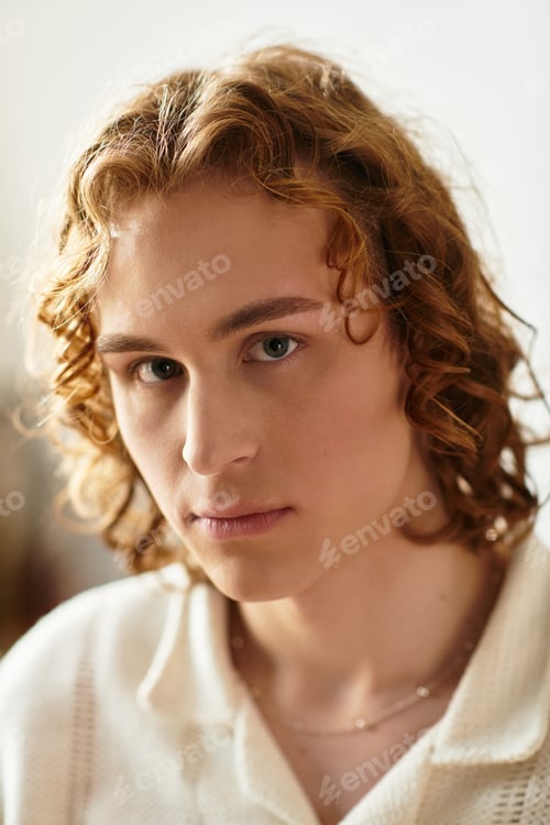 Preview: Capturing a moment of contemplation in a cozy home setting with a young man