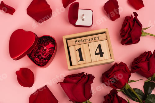 Preview: top view of red roses near calendar with 14 february, confetti and engagement ring around petals on