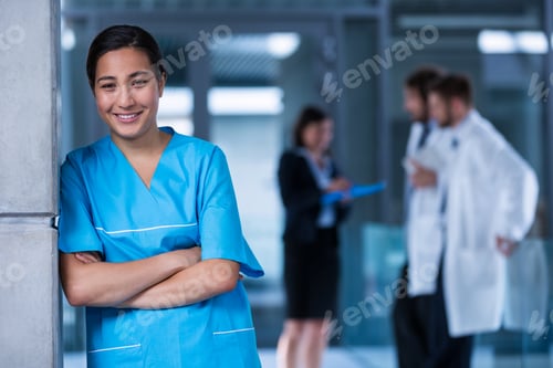 Preview: Smiling nurse standing in hospital