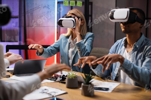 Preview: Business colleagues in VR glasses sitting at office room