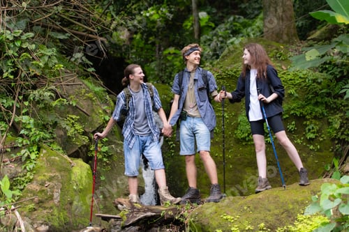 Preview: Group of young people hiking in the forest. Travel and adventure concept.