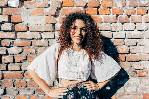 Preview: Woman posing against brickwall