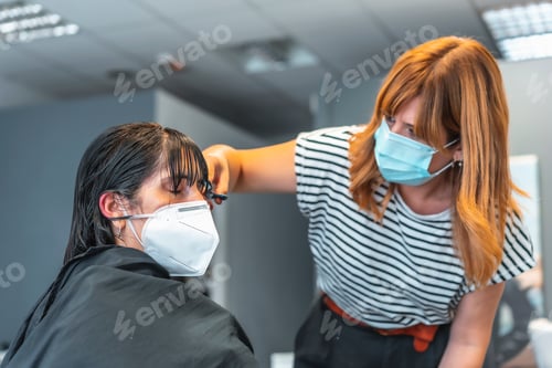 Preview: Hairdresser with face mask cutting bangs to the client