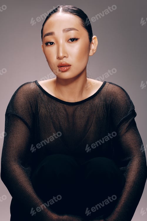 Preview: Asian woman fashion sitting on floor with hands on knees in sheer top