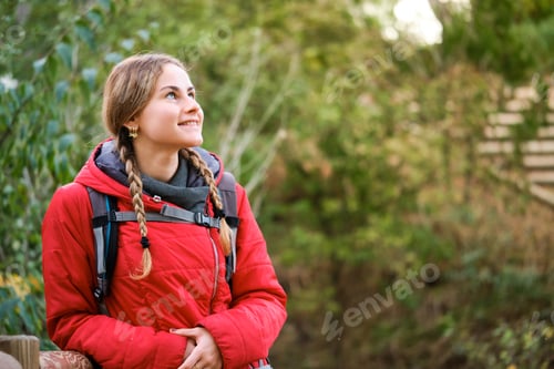 Preview: Smiling hiker resting and contemplating views in the forest.