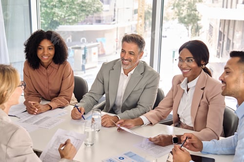 Preview: Happy diverse executive business people working together at meeting in office.