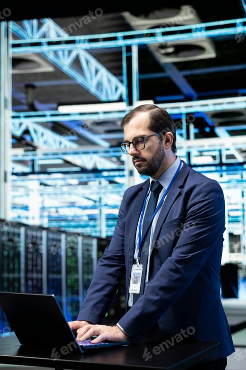Preview: Data center system administrator configuring server settings with laptop