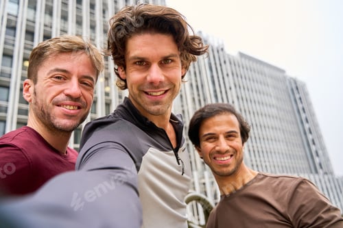 Preview: Three happy male friends taking a selfie in the city