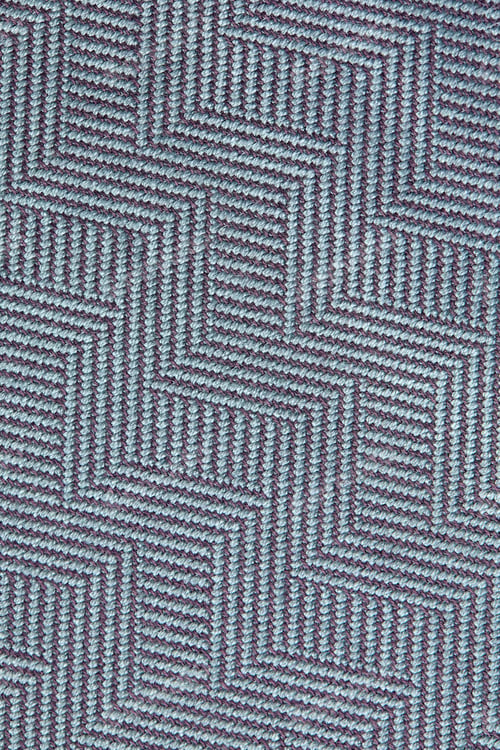 Vorschau: Gestrickte Textur. Textur aus Jacquardstoff mit graublauem geometrischem Muster. Gehäkeltes Mosaikmuster