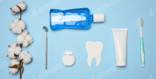 Preview: Mouthwash, toothpaste tube, dental floss and medical mirror on a blue background, oral hygiene