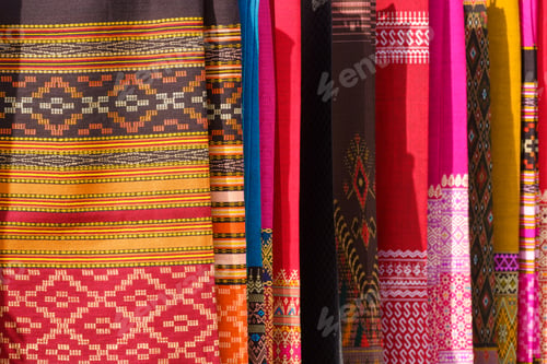 Preview: Colorful weaving garment background. Row of hanging multicolored cotton sarong clothing for selling