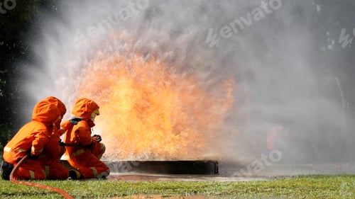 Preview: Firefighter fighting with flame using fire hose chemical water foam spray engine. Fireman hard hat