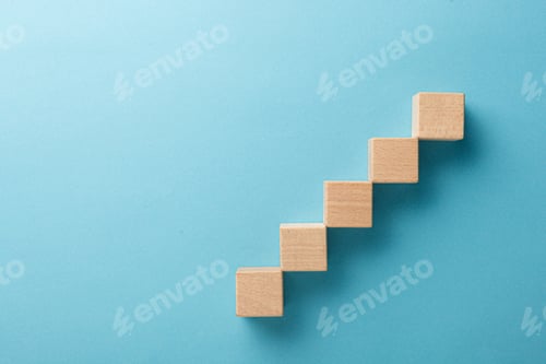 Preview: wooden cubes in the form of a ladder with a hand on a blue background