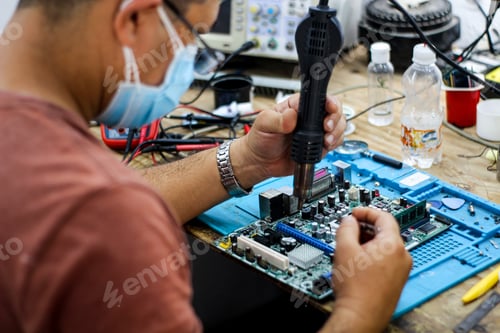 Preview: Hispanic man repairing the computer motherboard