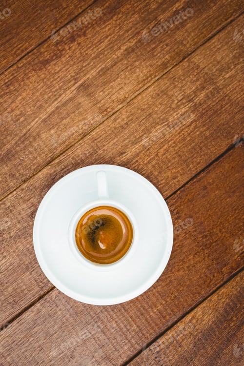 Preview: Above view of a coffee against wood desk